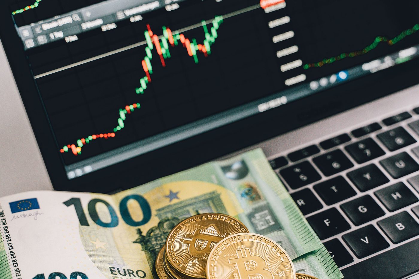 One-hundred-euro notes and coins on a trading screen